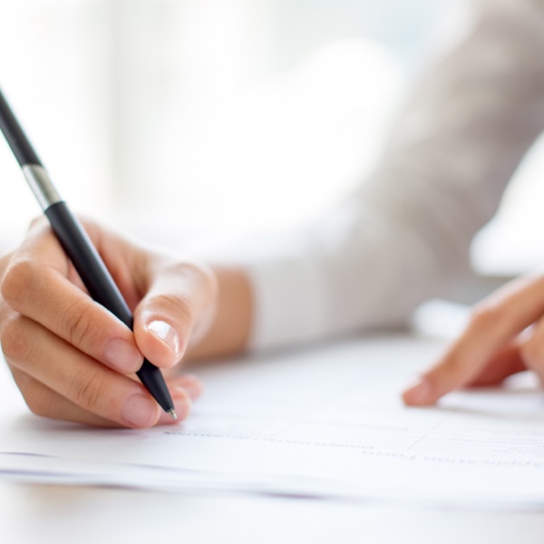 Person writing on a piece of paper